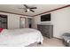Spacious main bedroom featuring wood-look floors, a TV, and a gray dresser at 1475 E Avenida Kino --, Casa Grande, AZ 85122