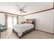 Bright main bedroom with wood-look flooring, ceiling fan, and a comfortable queen size bed at 1475 E Avenida Kino --, Casa Grande, AZ 85122