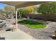 Picture of a cozy backyard featuring a well-kept lawn, small patio and lovely landscaping at 17705 N Larkspur Ln, Surprise, AZ 85374