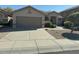 Charming single-story home featuring a well-manicured yard and a spacious two-car garage at 17705 N Larkspur Ln, Surprise, AZ 85374