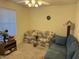 Bright living room with neutral carpet and cozy seating area at 17705 N Larkspur Ln, Surprise, AZ 85374