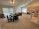 Bright living room with vaulted ceilings, dining table, and a breakfast bar at 17705 N Larkspur Ln, Surprise, AZ 85374