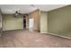 Cozy living room with a ceiling fan, neutral carpeting, and an open layout for versatile furniture arrangement at 17943 N Woodrose Ave, Surprise, AZ 85374