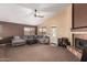 Comfortable living room featuring a corner fireplace, plush sofa, and ample space for entertaining guests at 17943 N Woodrose Ave, Surprise, AZ 85374