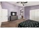 Main bedroom with an ensuite bathroom, dresser, TV, and double mirrored closet at 17943 N Woodrose Ave, Surprise, AZ 85374