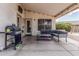 Covered patio with seating area and barbeque grill, perfect for entertaining at 17943 N Woodrose Ave, Surprise, AZ 85374