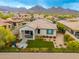 An aerial view showcases a home with a manicured backyard and mountain views at 18502 N 98Th Way, Scottsdale, AZ 85255
