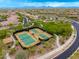 An aerial shot shows community tennis courts surrounded by green landscaping at 18502 N 98Th Way, Scottsdale, AZ 85255