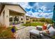 A serene backyard boasts a covered patio, lounge seating, and lush landscaping at 18502 N 98Th Way, Scottsdale, AZ 85255