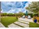 Beautiful backyard with manicured lawn, patio with seating, and lush landscaping at 18502 N 98Th Way, Scottsdale, AZ 85255