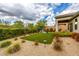 A landscaped backyard offers a pristine artificial lawn, patio, and beautiful greenery at 18502 N 98Th Way, Scottsdale, AZ 85255