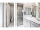 Well-lit bathroom featuring a walk-in shower with glass doors, a vanity with a sink, and neutral finishes at 18502 N 98Th Way, Scottsdale, AZ 85255