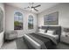Staged bedroom with a large bed, arched windows, and contemporary decor for a peaceful ambiance at 18502 N 98Th Way, Scottsdale, AZ 85255