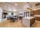 Spacious common area featuring ample seating, a modern kitchen, and sleek design at 18502 N 98Th Way, Scottsdale, AZ 85255