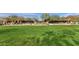 Expansive community green space with manicured lawn and pergola-covered seating areas at 18502 N 98Th Way, Scottsdale, AZ 85255
