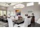 Elegant dining room with modern chandelier, dark wood floors, and open floor plan to living room at 18502 N 98Th Way, Scottsdale, AZ 85255