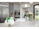 Spacious kitchen island featuring a sink, modern faucet, and stylish pendant lighting at 18502 N 98Th Way, Scottsdale, AZ 85255