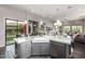 Stylish kitchen with a large island, farmhouse sink, and open concept design to the living area at 18502 N 98Th Way, Scottsdale, AZ 85255