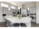 Modern kitchen featuring stainless steel appliances, gray cabinetry, and a large center island at 18502 N 98Th Way, Scottsdale, AZ 85255