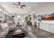 Open-concept living room with a wet bar, dining area, and a modern kitchen featuring stainless steel appliances at 18502 N 98Th Way, Scottsdale, AZ 85255