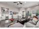 Spacious living room featuring a wet bar, dark wood floors, and a cozy seating area with outdoor access at 18502 N 98Th Way, Scottsdale, AZ 85255