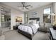 Stylish bedroom with neutral tones, fan, bedside tables and a seating area at 18502 N 98Th Way, Scottsdale, AZ 85255