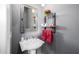 Chic powder room with pedestal sink, decorative mirror, and stylish gray walls at 18502 N 98Th Way, Scottsdale, AZ 85255