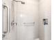 Modern shower featuring white subway tile, grab bars and built in storage niche at 18502 N 98Th Way, Scottsdale, AZ 85255