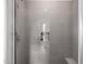 Modern shower showcasing sleek gray tiles, built-in niche, and comfortable seating at 18502 N 98Th Way, Scottsdale, AZ 85255