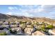 A high aerial view showcases the landscape, roofing, and surrounding neighborhood of this desert community at 2040 E Indigo Brush Rd, Phoenix, AZ 85048