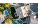 Overhead aerial view of the pool, green backyard with patio, and well-maintained landscaping at 2040 E Indigo Brush Rd, Phoenix, AZ 85048