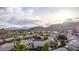 Picturesque aerial shot of homes in a serene desert community, with mountains in the backdrop and lush green landscaping at 2040 E Indigo Brush Rd, Phoenix, AZ 85048