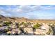 A high aerial view showcases the landscape, roofing, and surrounding neighborhood of this desert community at 2040 E Indigo Brush Rd, Phoenix, AZ 85048