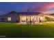 Well-manicured backyard with lush artificial turf, patio and covered seating area at 2040 E Indigo Brush Rd, Phoenix, AZ 85048