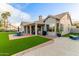 Expansive backyard featuring a covered patio, artificial grass, BBQ, and lounge area, perfect for outdoor living at 2040 E Indigo Brush Rd, Phoenix, AZ 85048
