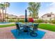 Inviting backyard with a patio, manicured lawn, and a dining area, perfect for outdoor gatherings and relaxation at 2040 E Indigo Brush Rd, Phoenix, AZ 85048