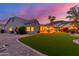 Backyard featuring well-maintained lawn, vibrant landscaping, and an inviting outdoor seating area at 2040 E Indigo Brush Rd, Phoenix, AZ 85048