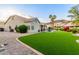 Lush backyard featuring artificial turf, desert landscaping, and a private pool at 2040 E Indigo Brush Rd, Phoenix, AZ 85048