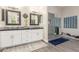 Stylish bathroom with a glass-enclosed shower, double sinks, white cabinets, and sleek fixtures at 2040 E Indigo Brush Rd, Phoenix, AZ 85048