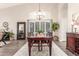 Elegant dining room features a modern chandelier, large windows, and neutral decor at 2040 E Indigo Brush Rd, Phoenix, AZ 85048