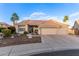 Beautiful home with a tile roof, three-car garage and desert landscaping under a blue sky at 2040 E Indigo Brush Rd, Phoenix, AZ 85048