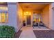 Inviting front porch with cozy seating, desert landscaping, and a stone walkway, creating a welcoming entrance at 2040 E Indigo Brush Rd, Phoenix, AZ 85048