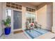 Inviting front porch with seating and decorative plants at the home's entrance at 2040 E Indigo Brush Rd, Phoenix, AZ 85048