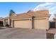 Well maintained beige single-story home with a three car garage and desert landscaping at 2040 E Indigo Brush Rd, Phoenix, AZ 85048