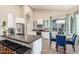 Modern kitchen with white cabinets, stainless steel appliances, and a breakfast nook at 2040 E Indigo Brush Rd, Phoenix, AZ 85048