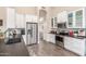 Well-appointed kitchen with stainless appliances, white cabinets, and modern countertops at 2040 E Indigo Brush Rd, Phoenix, AZ 85048