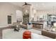 Open-concept living area with a view of the kitchen and backyard, featuring modern decor at 2040 E Indigo Brush Rd, Phoenix, AZ 85048
