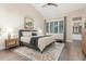 Cozy main bedroom with a king bed, decorative rug, and ensuite bathroom access, creating a private retreat at 2040 E Indigo Brush Rd, Phoenix, AZ 85048
