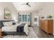 Tranquil bedroom featuring ensuite bath access, a king bed, a ceiling fan, and a decorative rug at 2040 E Indigo Brush Rd, Phoenix, AZ 85048