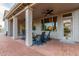 Covered outdoor patio with brick flooring, ceiling fans, and comfortable seating for relaxation and entertainment at 2040 E Indigo Brush Rd, Phoenix, AZ 85048